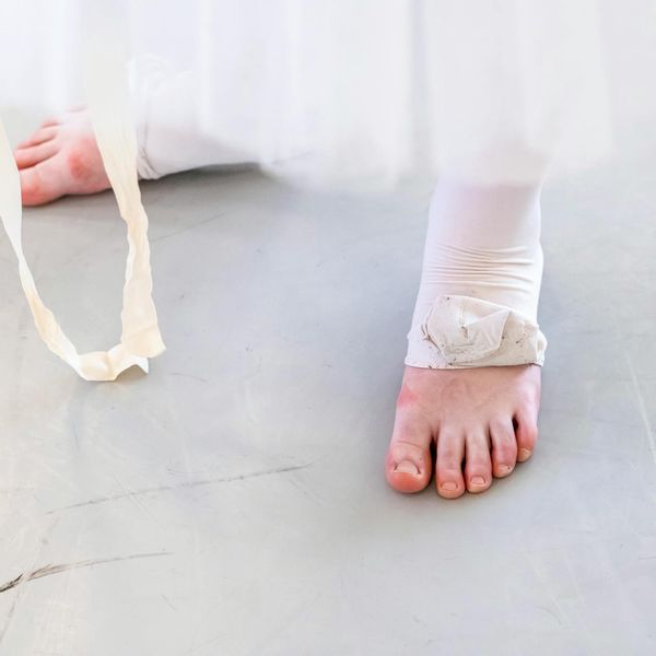 Close up of bare feet on a white floor